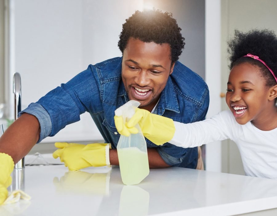 Shot of a little girl and her father enjoying their chores at home